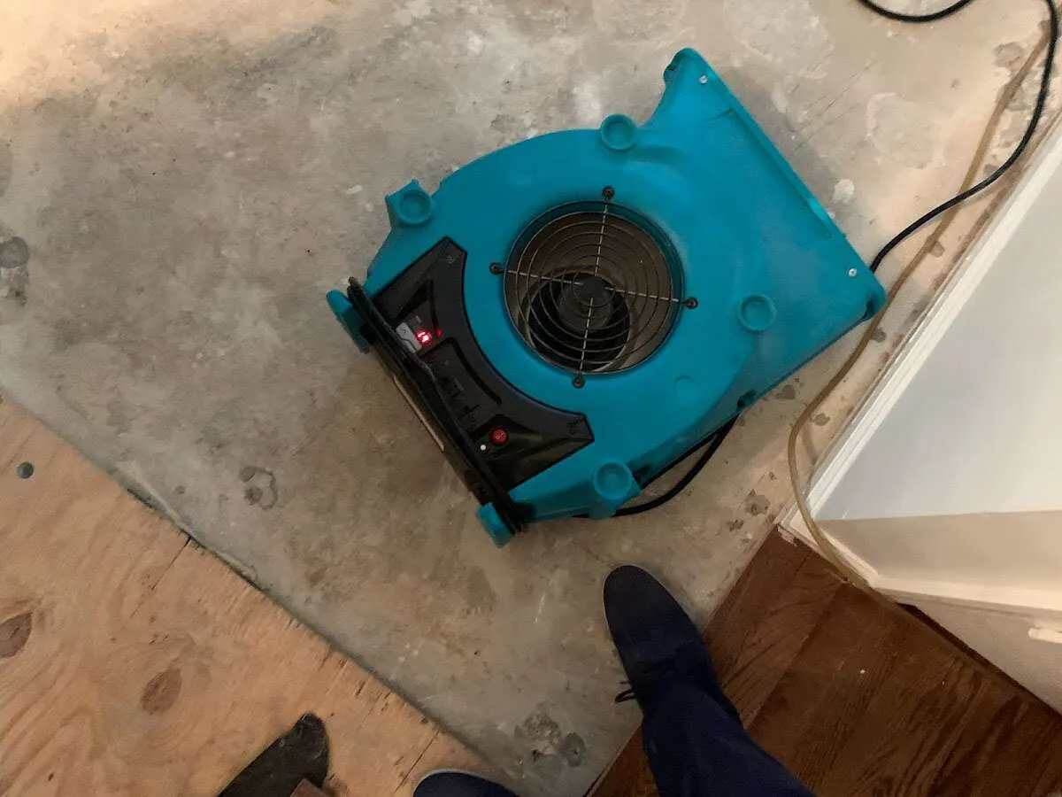 Air mover drying subfloor during Leak Detection & Repair in Smyrna